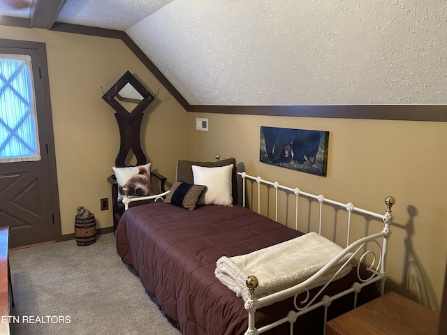 carpeted bedroom featuring a textured ceiling and vaulted ceiling