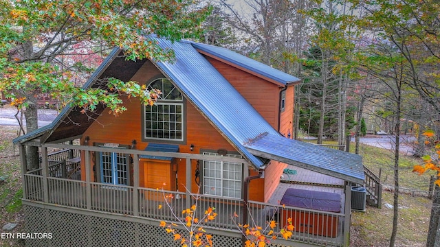 view of front of home featuring a deck and central AC