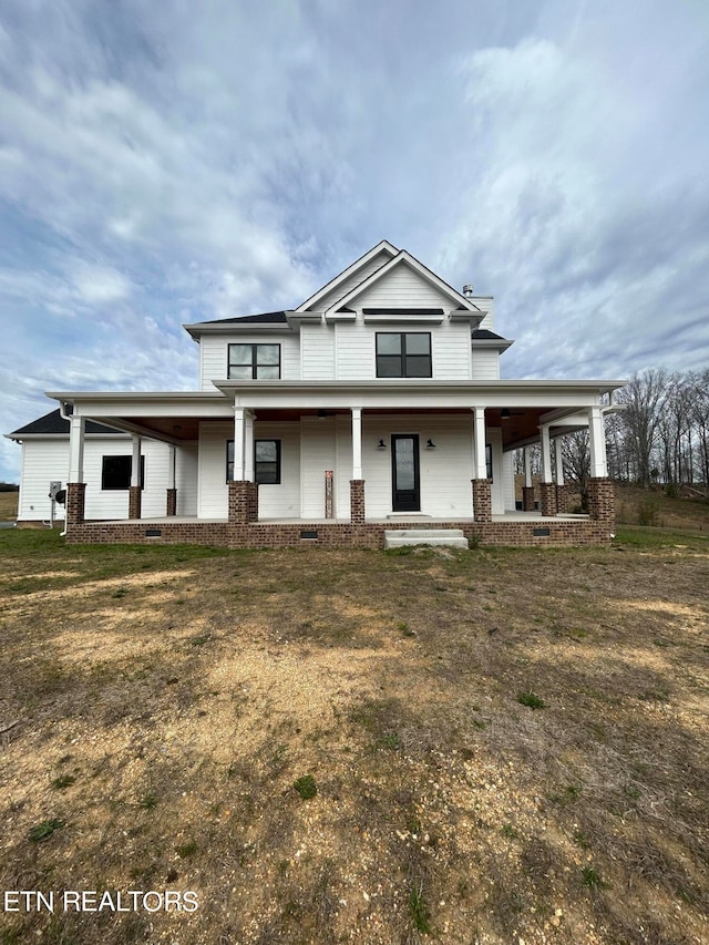 view of front facade with covered porch and a front yard