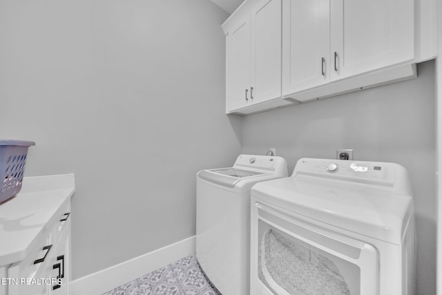 washroom featuring light tile flooring, cabinets, separate washer and dryer, and hookup for an electric dryer