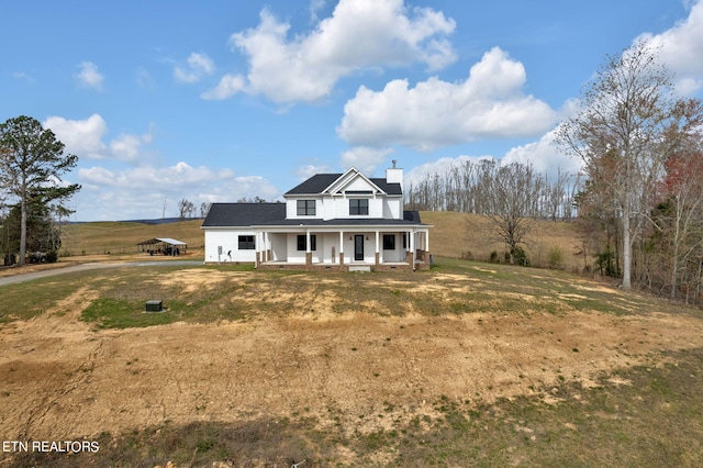 view of front of property with a front yard and covered porch