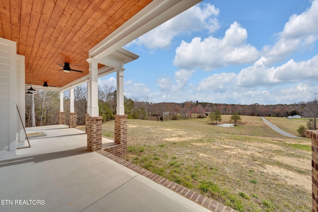 view of yard featuring ceiling fan and a patio