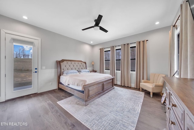 bedroom with access to exterior, light hardwood / wood-style floors, and ceiling fan