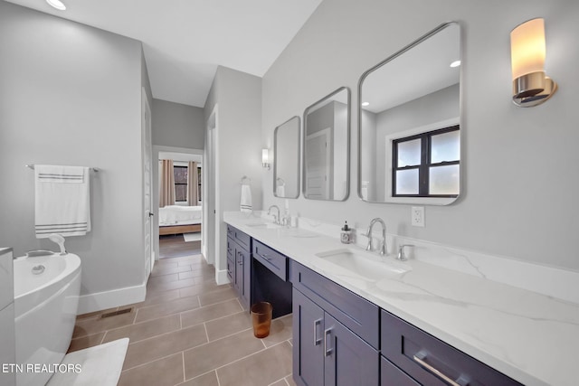 bathroom with dual bowl vanity, tile flooring, and a bath to relax in