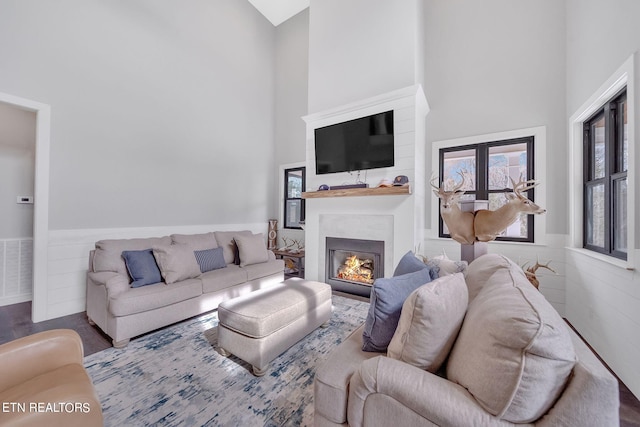 living room featuring dark hardwood / wood-style floors and a towering ceiling