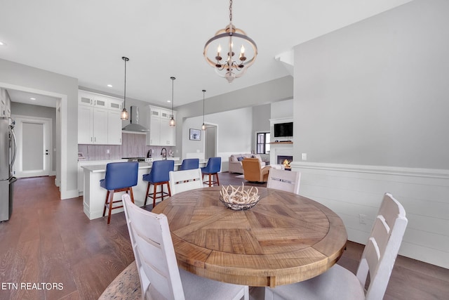 dining area featuring dark hardwood / wood-style floors and a chandelier