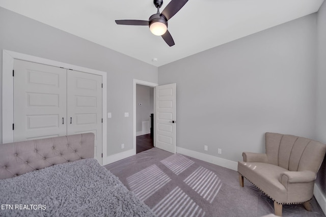 bedroom featuring ceiling fan, a closet, and dark wood-type flooring