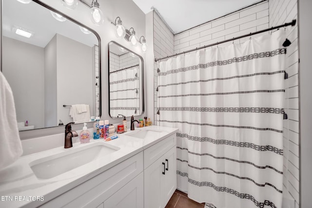 bathroom with tile flooring, vanity with extensive cabinet space, and dual sinks