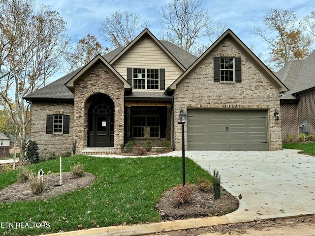 view of front of house with a garage and a front lawn