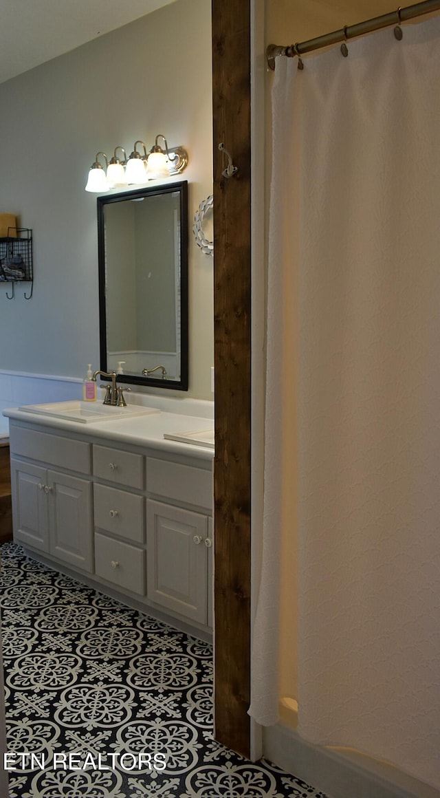 full bathroom with tile patterned flooring and vanity