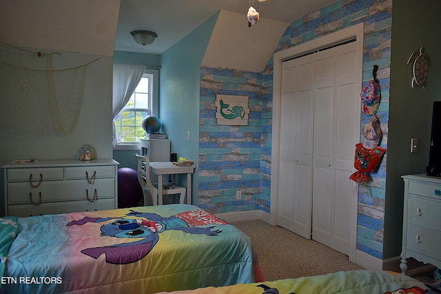 carpeted bedroom featuring baseboards and a closet