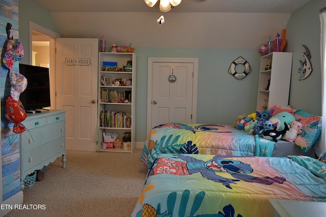 carpeted bedroom with lofted ceiling