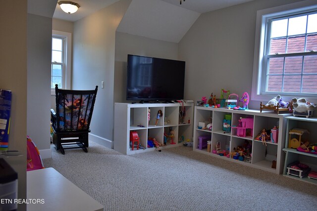 recreation room featuring lofted ceiling and carpet flooring