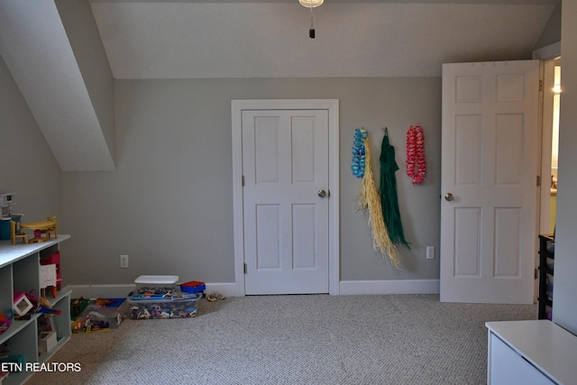 playroom featuring lofted ceiling and carpet flooring