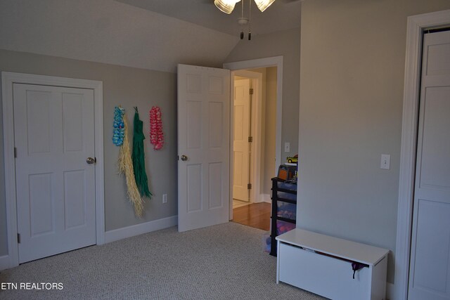 carpeted bedroom featuring lofted ceiling