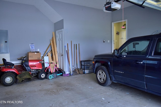 garage with electric panel and a garage door opener