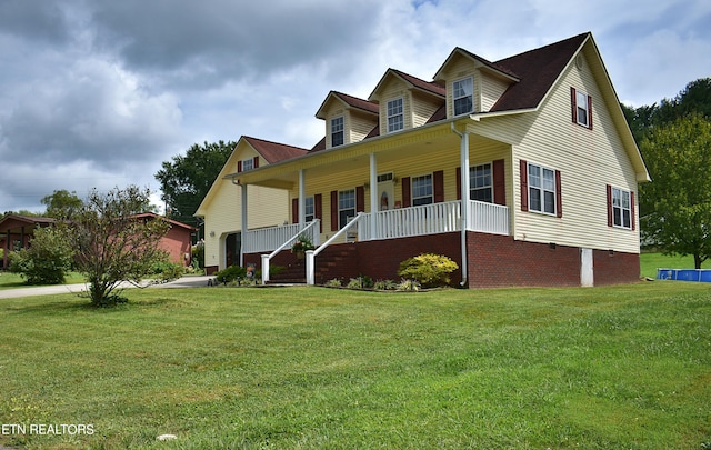 view of front of house featuring covered porch and a front yard