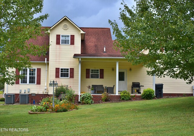 view of front of property featuring a front lawn and central AC unit