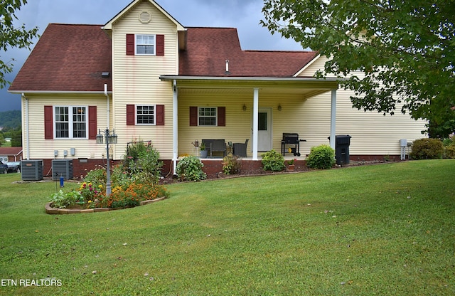 rear view of house with roof with shingles, a lawn, and central air condition unit