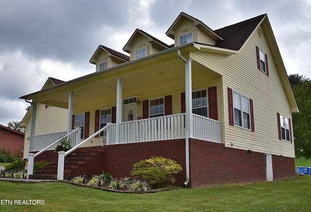 view of front of home featuring a front lawn and a porch