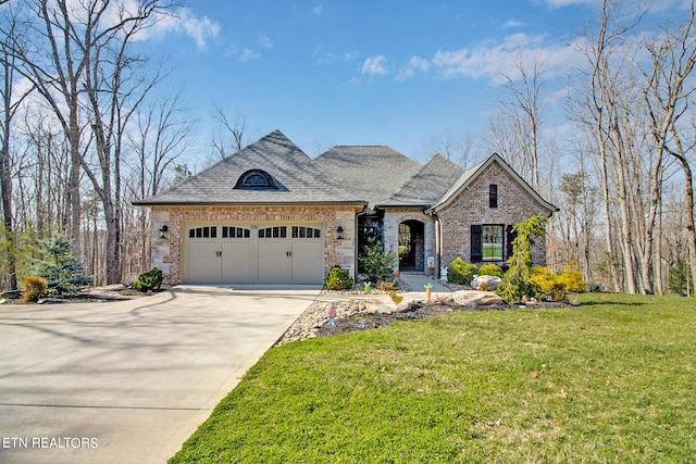 french provincial home featuring a garage and a front lawn