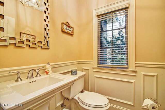 bathroom featuring plenty of natural light, sink, and toilet