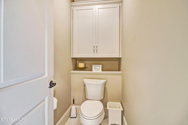 bathroom with toilet and tile floors