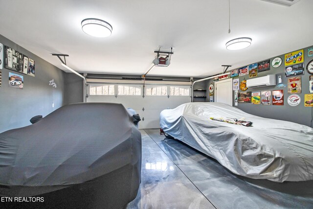 garage featuring a wall unit AC and a garage door opener