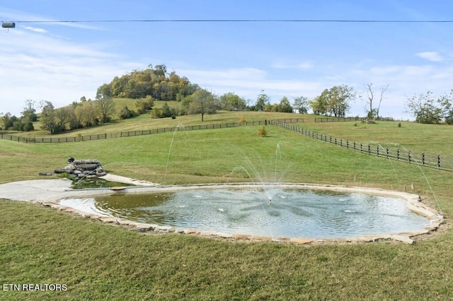 surrounding community featuring a rural view and a lawn