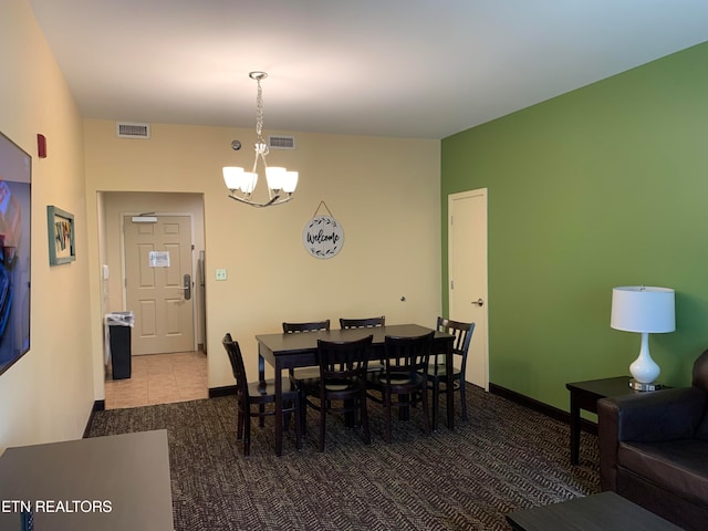 carpeted dining room featuring a chandelier