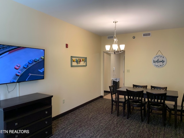 carpeted dining area featuring a chandelier