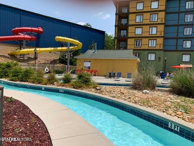 view of pool featuring a water slide