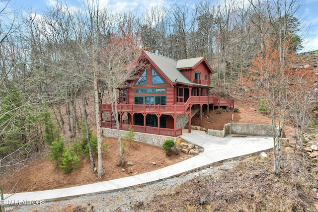 log-style house featuring a wooden deck