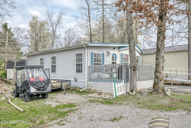 back of house featuring a wooden deck