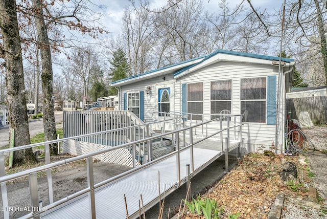 rear view of house featuring a wooden deck