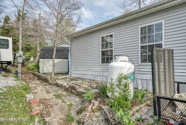 view of property exterior with a storage shed