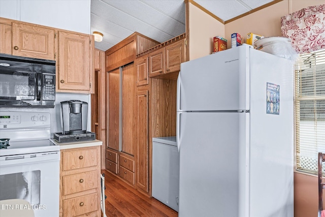 kitchen with white appliances, ornamental molding, dark hardwood / wood-style floors, and washer / dryer