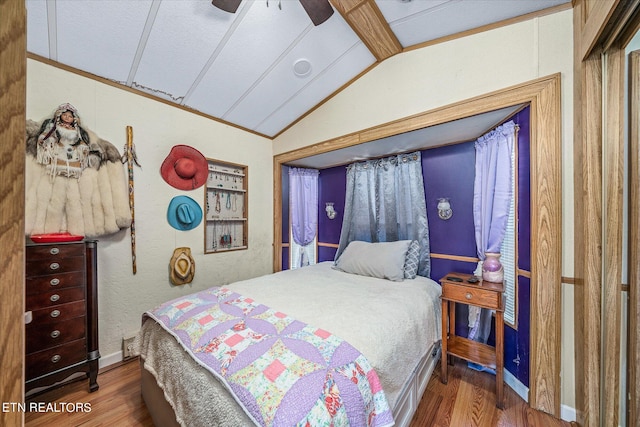 bedroom featuring ceiling fan, dark hardwood / wood-style floors, and vaulted ceiling