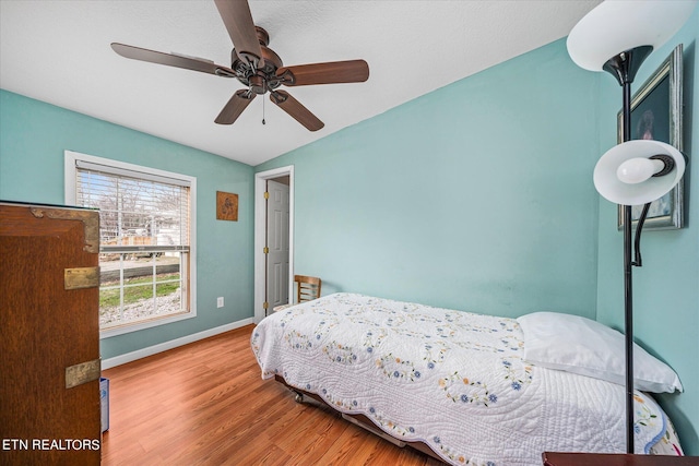 bedroom featuring lofted ceiling, ceiling fan, and light hardwood / wood-style flooring