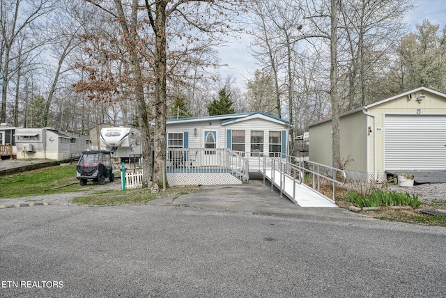 manufactured / mobile home featuring an outdoor structure and a garage