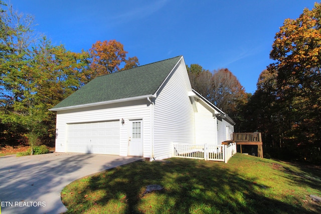 view of home's exterior featuring a wooden deck, a garage, and a lawn