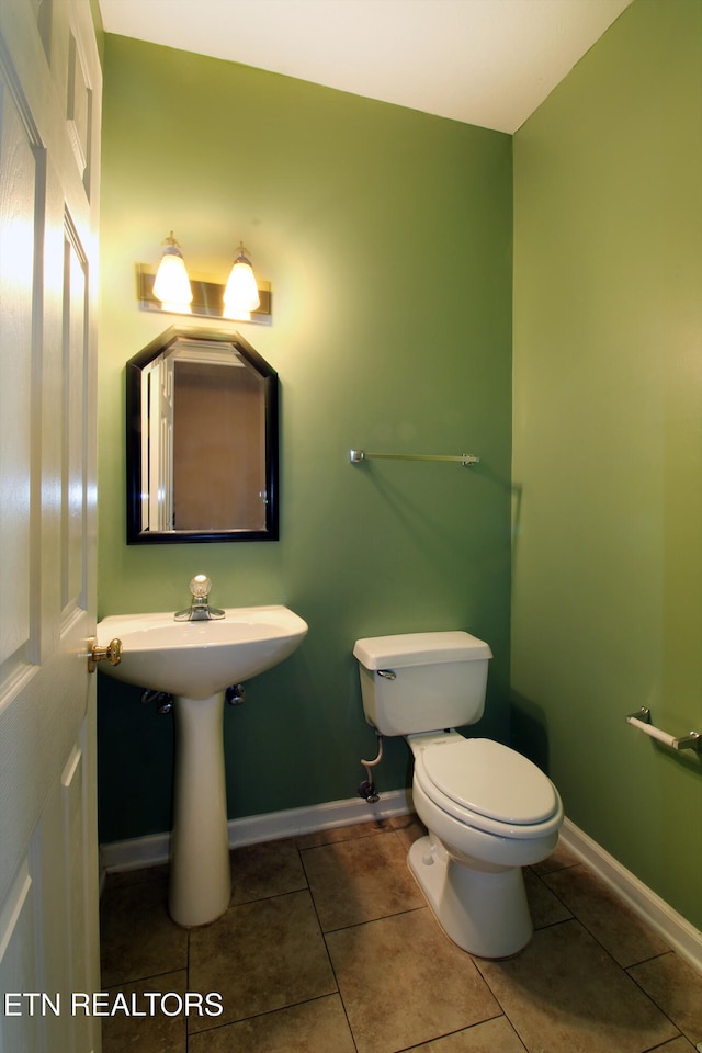 bathroom featuring tile patterned flooring and toilet