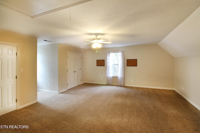 interior space featuring lofted ceiling, carpet floors, and ceiling fan