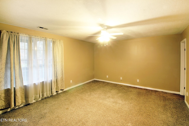 carpeted empty room featuring ceiling fan