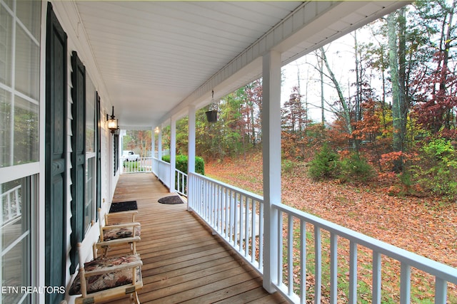 wooden terrace featuring covered porch