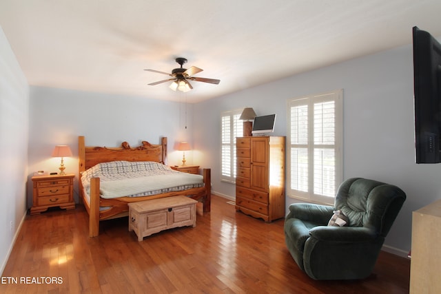 bedroom with ceiling fan and light hardwood / wood-style floors