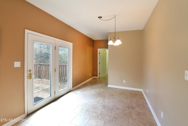 unfurnished room with an inviting chandelier and light tile patterned floors