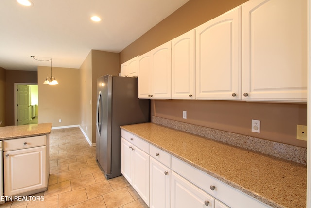 kitchen with white cabinetry, light stone counters, decorative light fixtures, and stainless steel refrigerator with ice dispenser