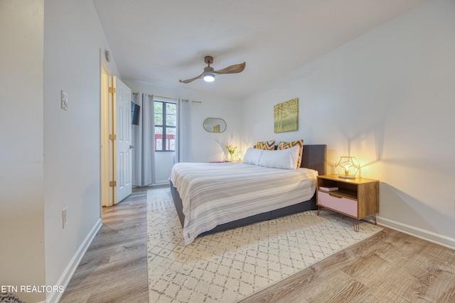 bedroom with ceiling fan and light hardwood / wood-style flooring