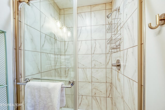 bathroom featuring a shower with shower door